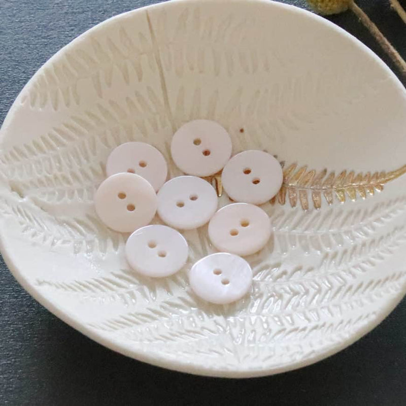 Flat mother-of-pearl buttons with 2 holes