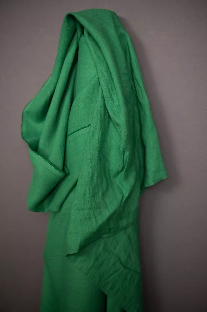 Green fabric draped over a gray background
