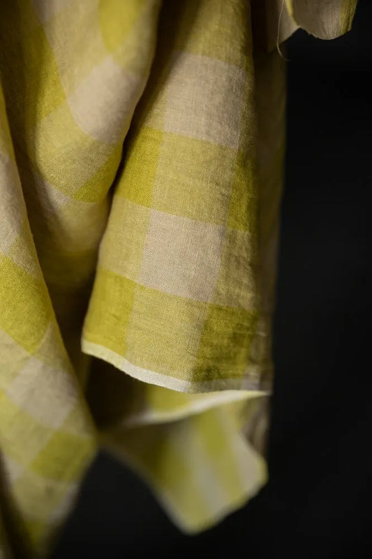 Close-up of a green and white checkered fabric against a black background